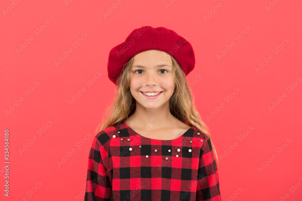 How wear beret like fashion girl. Kid little girl with long hair posing in hat and checkered dress on red background. Fashionable beret hat for female. French style beret hat. Beret style inspiration How wear beret like fashion girl. Kid little girl with long hair posing in hat and checkered dress on red background. Fashionable beret hat for female. French style beret hat. Beret style inspiration