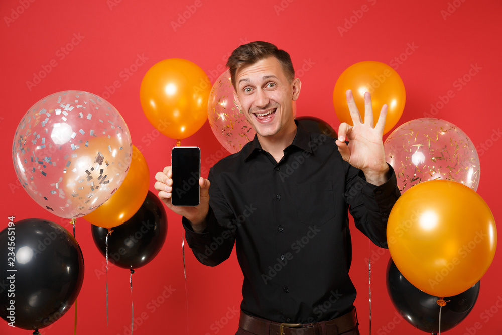 Excited Young Man In Black Classic Shirt Holding Mobile Phone With Blank Black Empty Screen Showing Excited Young Man In Black Classic Shirt Holding Mobile Phone With Blank Black Empty Screen Showing