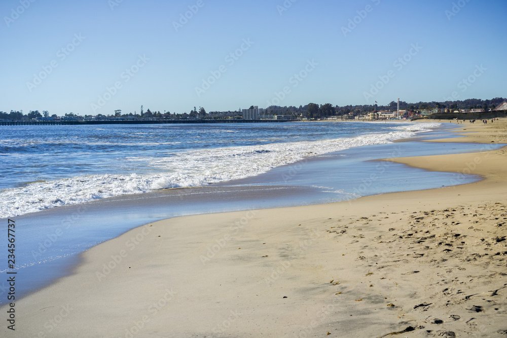 Seabright State beach on a sunny afternoon, Santa Cruz beach Boardwalk and wharf in the background, Santa Cruz, California