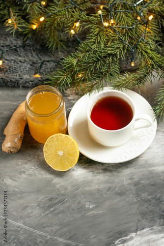 Lemon and ginger jam with toasts and spices, tea and a branch of the Christmas tree with space for an inscription. The concept of heat, recommendations for the health and support of the immune system