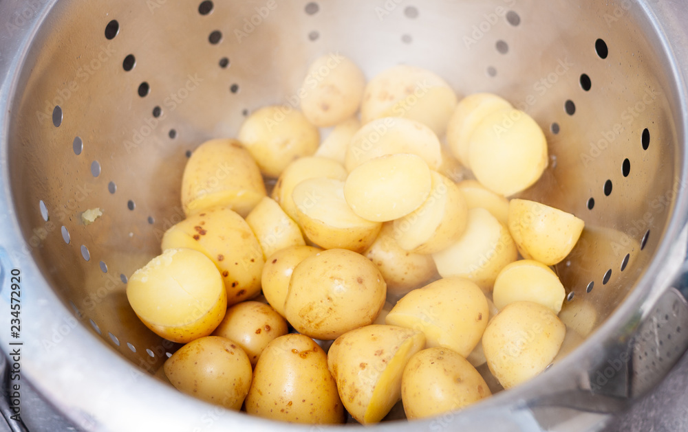 Steaming hot cooked baby potatoes in a colander Steaming hot cooked baby potatoes in a colander
