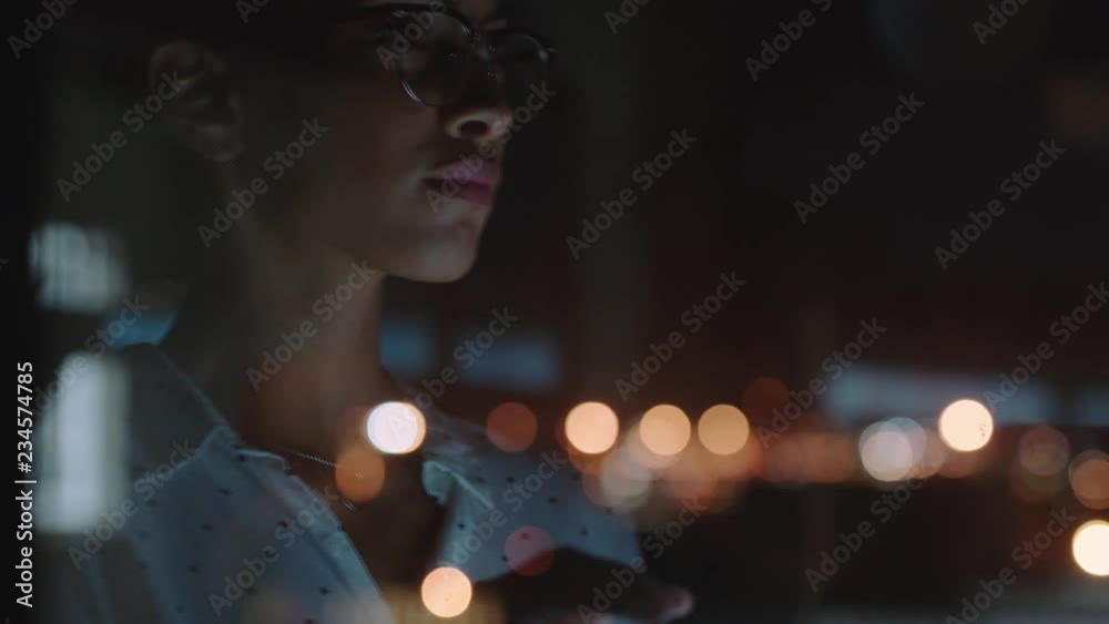close up beautiful business woman working late using tablet computer browsing research data statistics on screen brainstorming successful project deadline strategy looking out window planning ahead