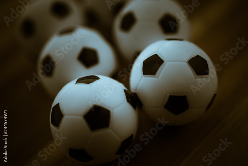 Soccer Football balls on dark wooden background. Toned photo.