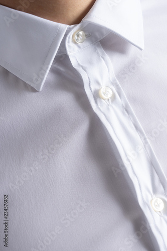 Classic cotton white shirt close up on buttons and collar. Business meeting.