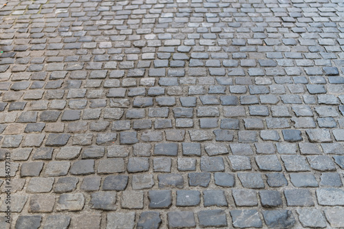Dark paving stone roadway at european old city