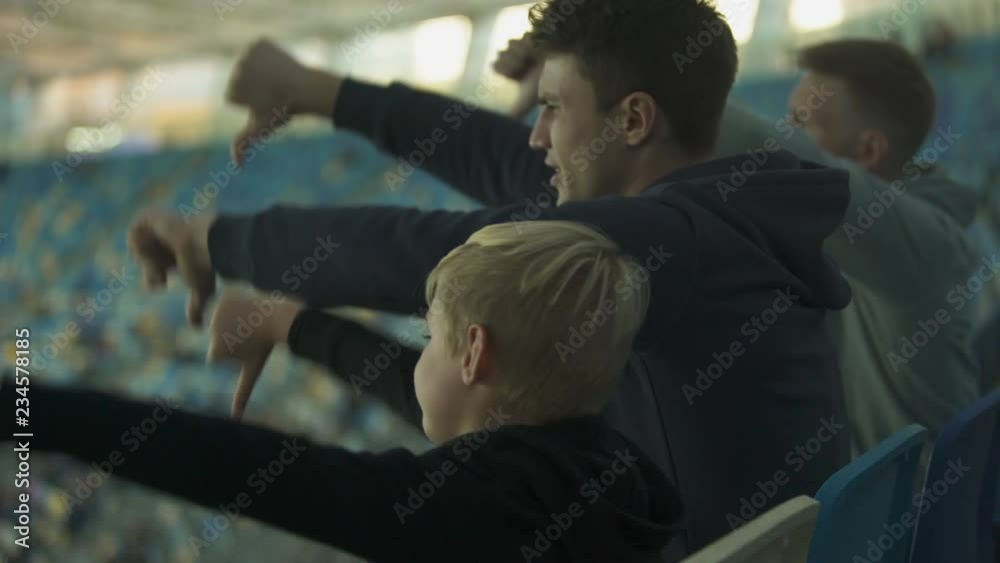 Student fans and little boy booing sport game at stadium, watching junior match