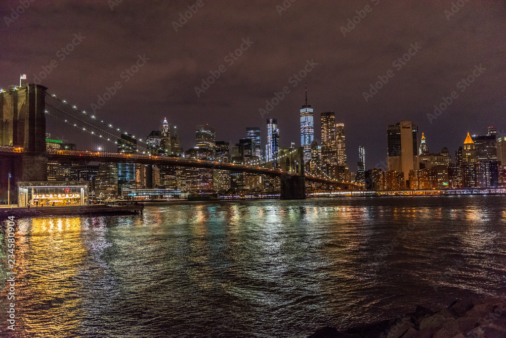 The Lights of Manhattan Surround the Brooklyn Bridge as It Crosses New York City's East River