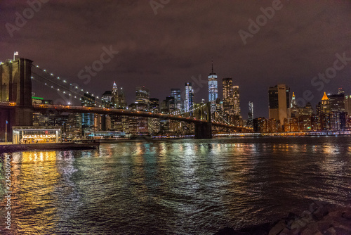 The Lights of Manhattan Surround the Brooklyn Bridge as It Crosses New York City s East River