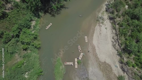 Aerial top view of bamboo rafts on a river in Vietnam. Amazing jungle scenery.   