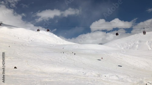 sunny day winter time gudauri ski resort lift ride slow motion panorama 4k georgia
 photo