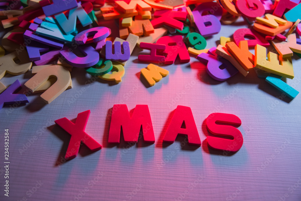 Fototapeta premium Children's word on wooden table: XMAS