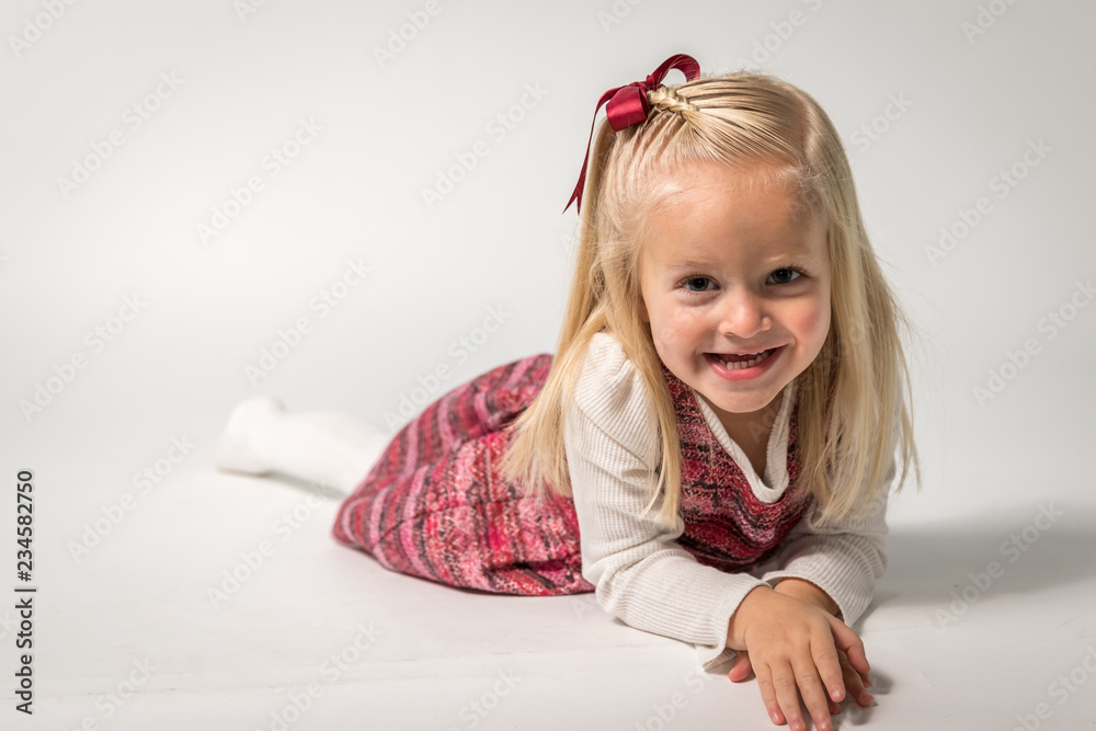 Little Girl Smiling at Camera on a White Background Little Girl Smiling at Camera on a White Background