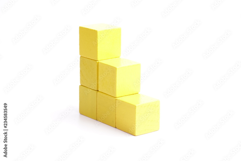 Naklejka premium Yellow wooden blocks on white background.