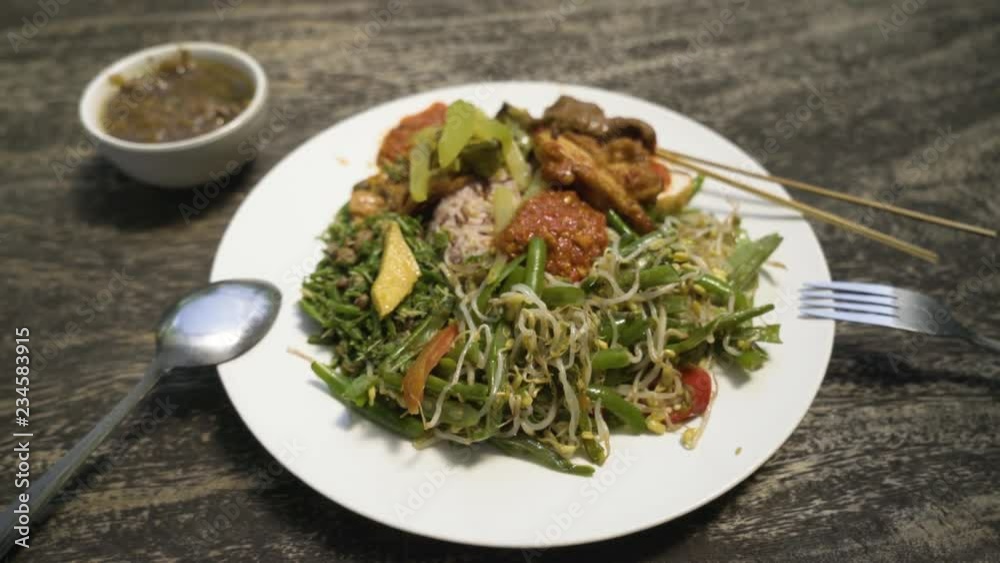 Close up of an Indonesian dish. Vegan nasi campur with banana soup Close up of an Indonesian dish. Vegan nasi campur with banana soup