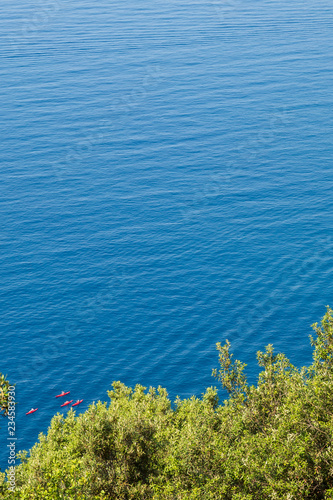Fototapeta Naklejka Na Ścianę i Meble -  Group of red kayaks off the Ligurian coast