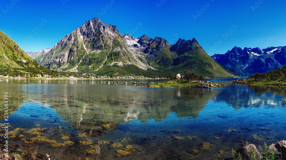 The landscape of Norway in the summer. View of Laupstadosen is a bay near Austvagoya Island, the northeasternmost of the larger islands in the Lofoten archipelago in Norway.