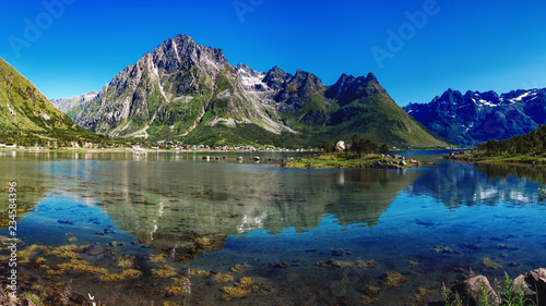 Fototapeta Naklejka Na Ścianę i Meble -  The landscape of Norway in the summer. View of Laupstadosen is a bay near Austvagoya Island, the northeasternmost of the larger islands in the Lofoten archipelago in Norway.