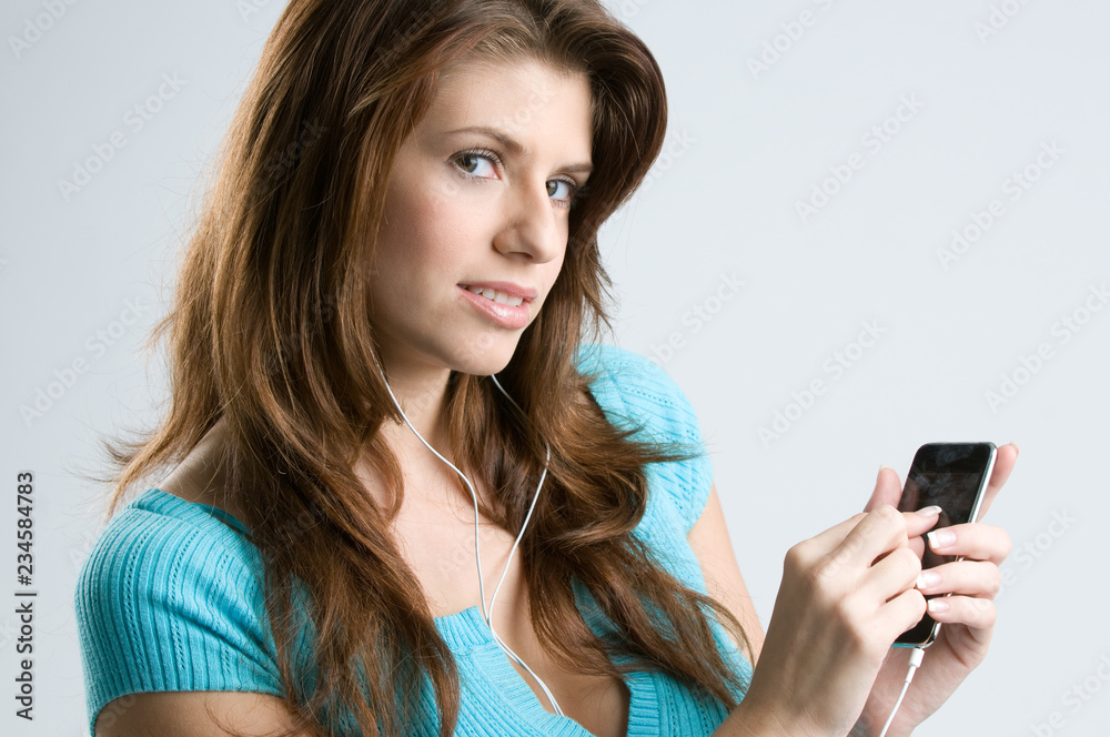 Fototapeta premium Young brunette woman using a smartphone