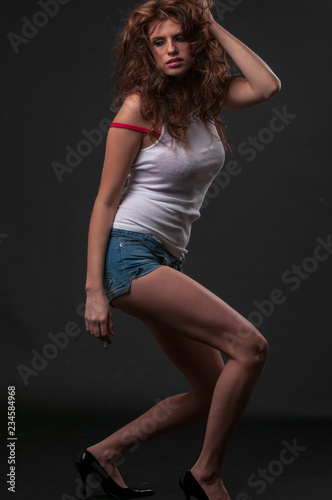 Young woman in wife beater and blue jeans shorts