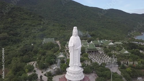 2K Aerial view Lady Buddha close-up Da Nang Vietnam. Big white buddha statue top view. Linh Ung pagoda in Danang city. 