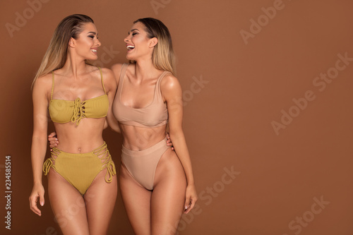Beautiful sexy twins sisters having fun together photo