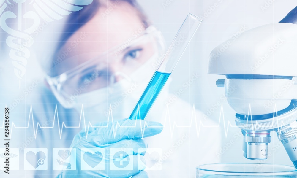 Fototapeta premium Young Female Scientist Working with Microscope