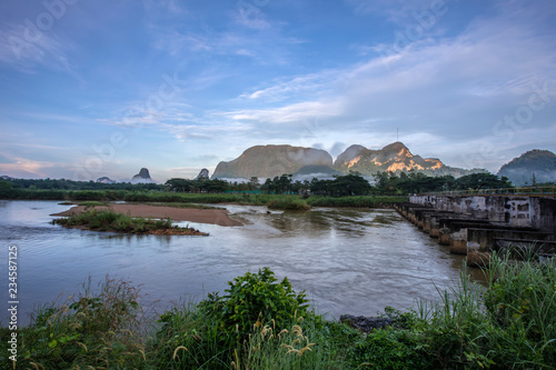 Meadow,lake,mountains on cloudy blue sky background in Phang Nga province,South of Thailand