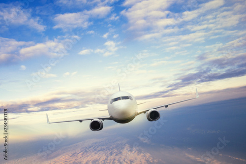 Commercial Airplane flying above a beautiful clouds.