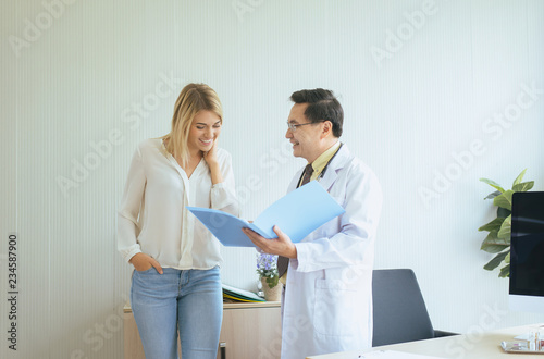 Man doctor examining  woman patient and follow up treatment at hospital Happy and smiling people