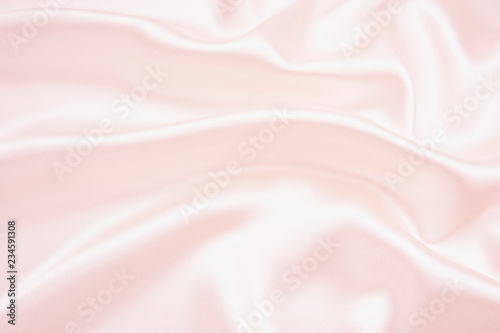 The texture of the satin fabric of pink color for the background