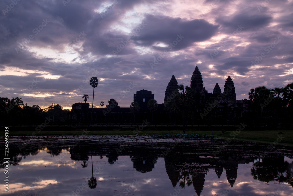 Golden sky form Sunrise view of ancient temple complex at entrance of Angkor Wat in Siem Reap, Cambodia the World Heritage (one of Seven Wonders of the Word).