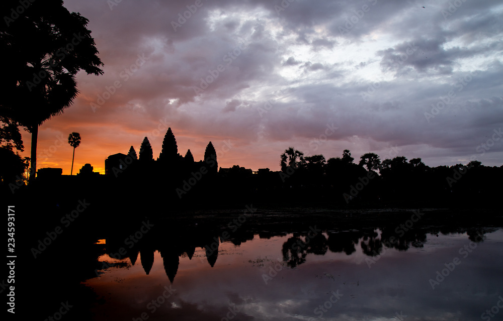 Golden sky form Sunrise view of ancient temple complex at entrance of Angkor Wat in Siem Reap, Cambodia the World Heritage (one of Seven Wonders of the Word).