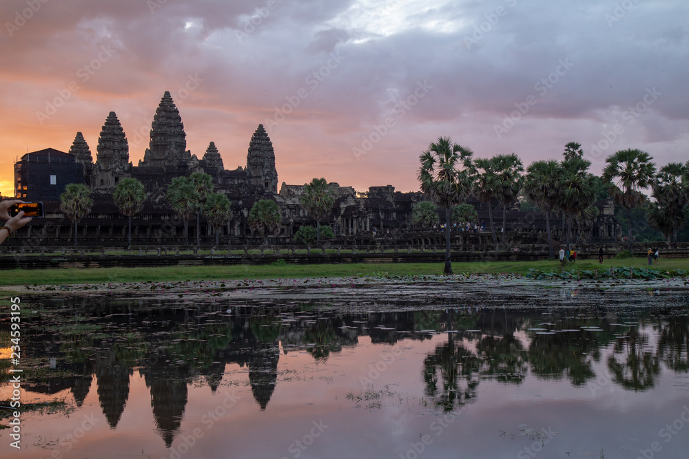 Golden sky form Sunrise view of ancient temple complex at entrance of Angkor Wat in Siem Reap, Cambodia the World Heritage (one of Seven Wonders of the Word). Golden sky form Sunrise view of ancient temple complex at entrance of Angkor Wat in Siem Reap, Cambodia the World Heritage (one of Seven Wonders of the Word).