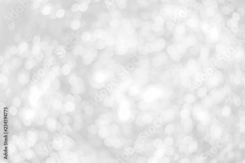 Abstract glamorous white and silver bokeh lights glitter sparkle. Defocused background have luxury golden color party invite for birthday, anniversary, holliday, new year xmas or snow christmas blur.