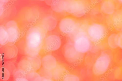 Abstract glamorous pink and orange bokeh lights glitter sparkle. Defocused background have luxury golden color party invite for birthday, anniversary, holliday, new year xmas or snow christmas blur.