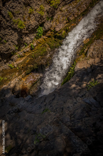 Cascading Waterfall Disappearing into Hole In Rocks