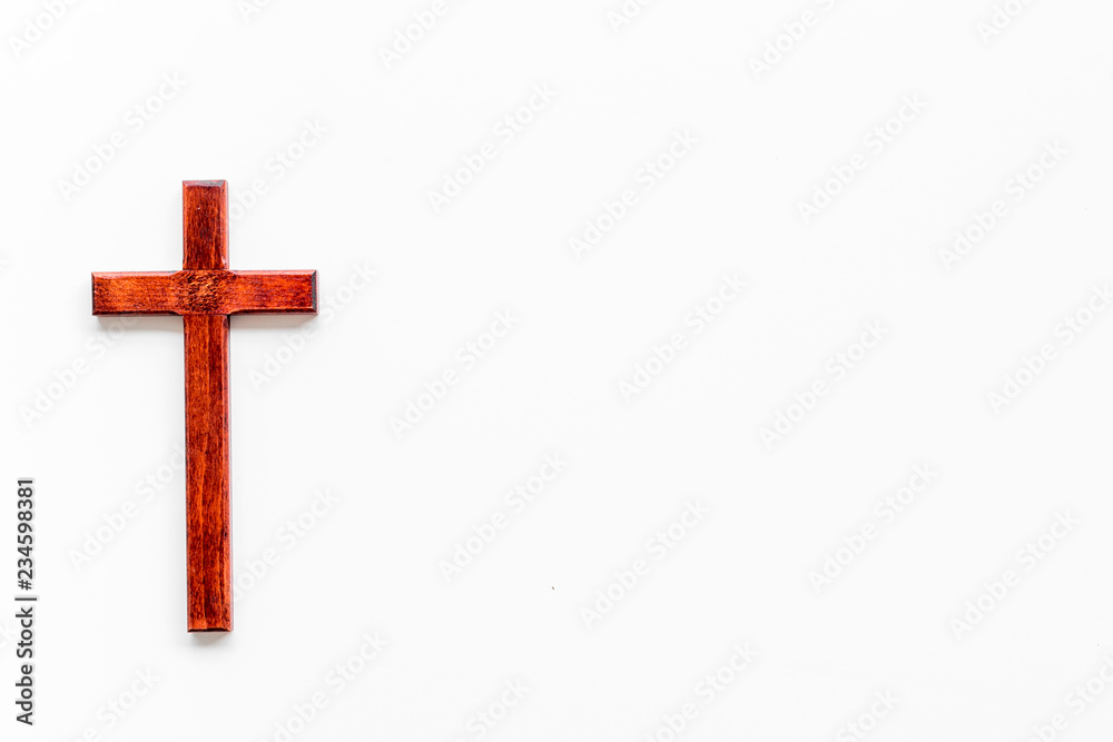 Funeral concept. Wooden cross on white background top view copy space