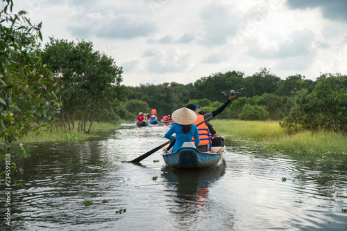 Tourism rowing boat in cajuput forest in floating water season in Mekong delta  Vietnam