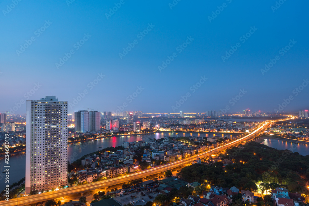 Fototapeta premium Aerial skyline view of Hanoi at Linh Dam lake, Belt Road No. 3. Hanoi cityscape by sunset period