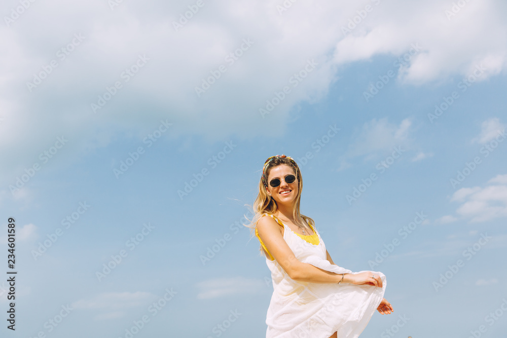 Beautiful woman in sunglasses relaxing at beach on a sunny day .. Beautiful woman in sunglasses relaxing at beach on a sunny day ..