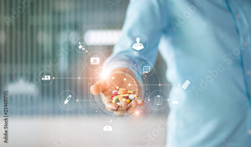 Medicine. Human holding drugs tablets and pills in hand with icon medical network connection on modern virtual screen interface, medicines, pharmaceutics and medical technology network concept photo