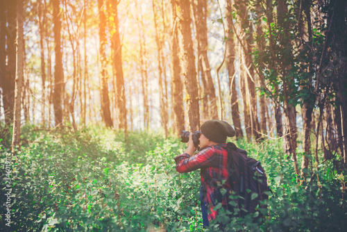 Young professional traveler man with camera shooting outdoor, fantastic mountain landscape