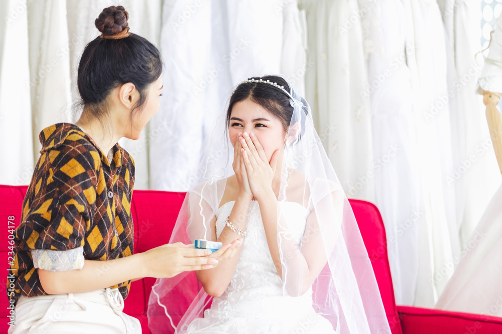 Naklejka premium Asian designer working in wedding fashion store shop