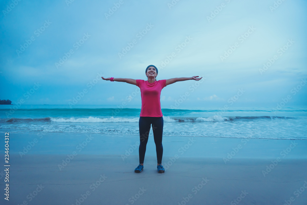 Asian women running workout jogging on the beach in the morning. extend the arms relax. Asian women running workout jogging on the beach in the morning. extend the arms relax.