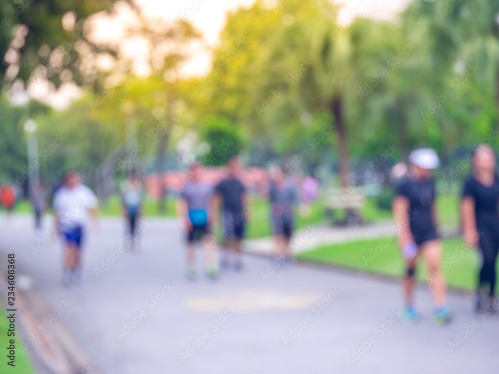 Blurred people walk, running in the park Blurred people walk, running in the park