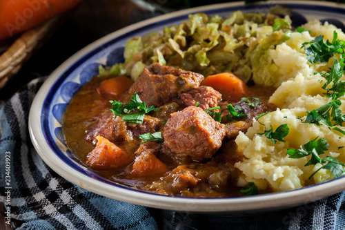 Traditional irish stew served with potatoes and cabbage