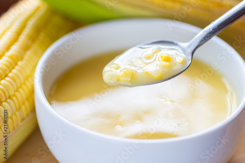 Hot corn soup in spoon