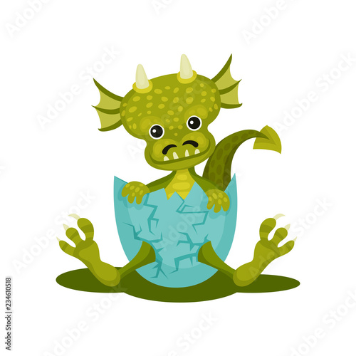 Fotografie Funny baby dragon in blue broken egg shell