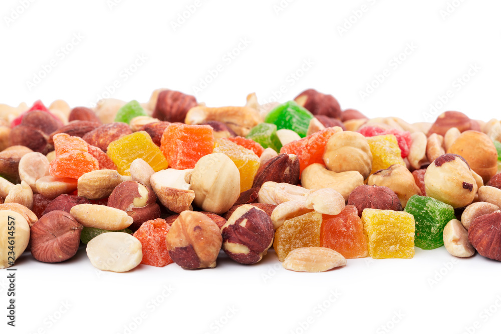Pile of toasted nuts and candied fruit isolated on white background Pile of toasted nuts and candied fruit isolated on white background