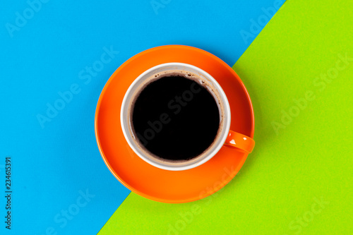 cup of coffee and saucer on color background
